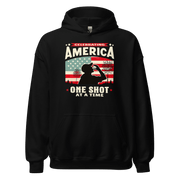 Hoodie with Celebrating America One Shot at a Time text, silhouette of a man drinking a shot, and distressed American flag background. Perfect for 4th of July.