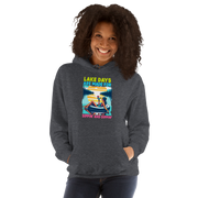 Hoodie with "Lake Days Are Made for Sipping and Dipping," showing a woman on a tube float with a cocktail, lake and sunset scene.