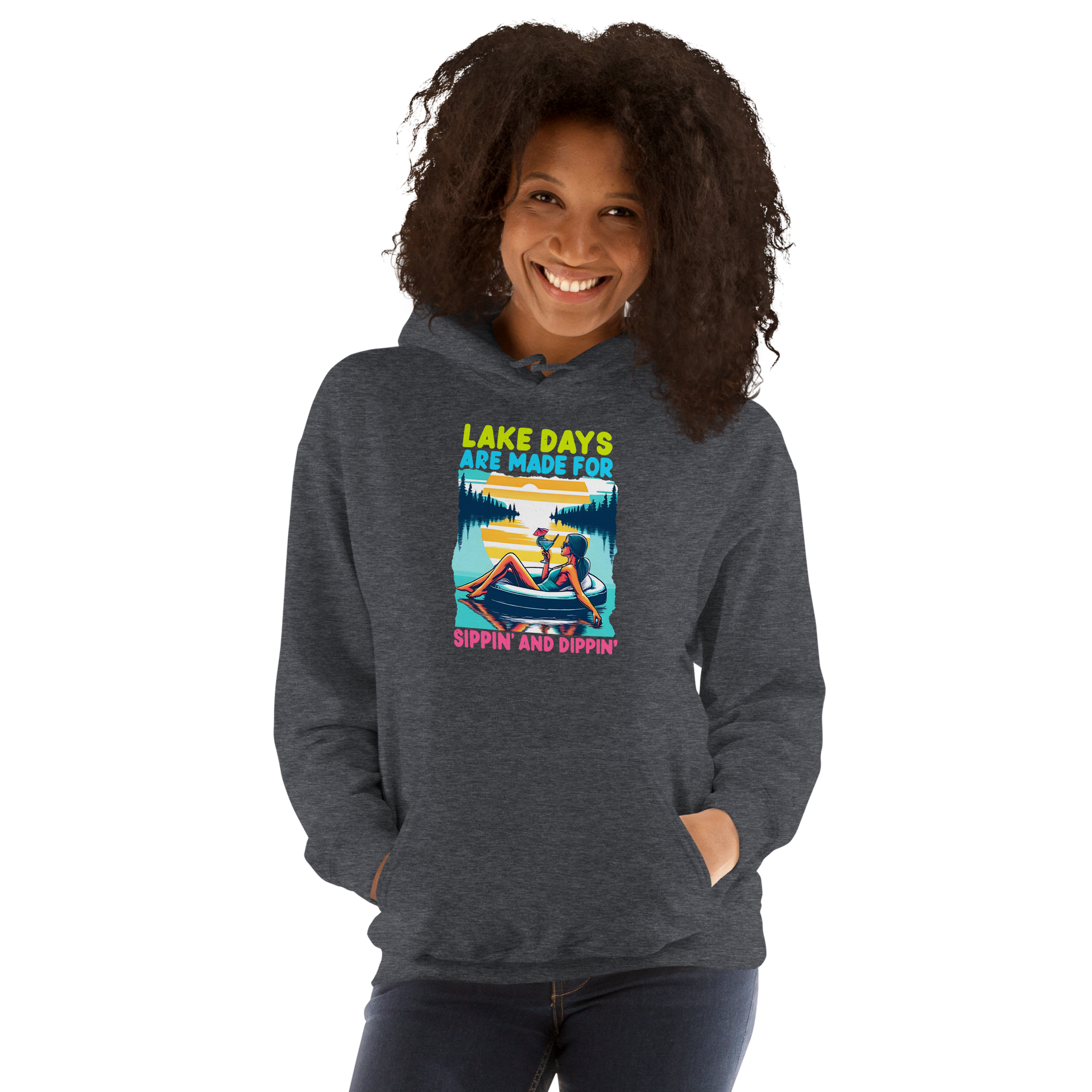 Hoodie with "Lake Days Are Made for Sipping and Dipping," showing a woman on a tube float with a cocktail, lake and sunset scene.