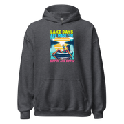 Hoodie with "Lake Days Are Made for Sipping and Dipping," showing a woman on a tube float with a cocktail, lake and sunset scene.