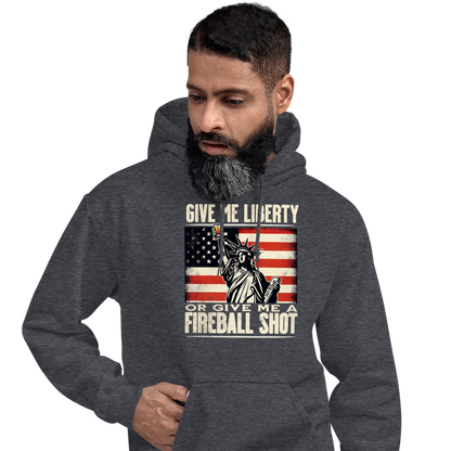 Hoodie with 'Give Me Liberty or Give Me a Fireball Shot' text, Statue of Liberty holding a shot glass, and distressed American flag background. Perfect for 4th of July.