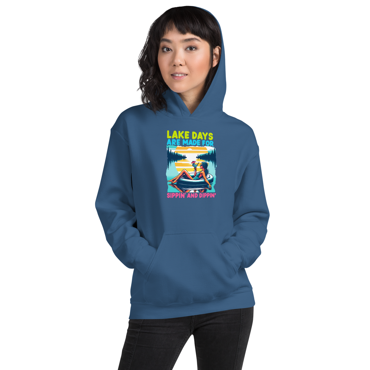 Hoodie with "Lake Days Are Made for Sipping and Dipping," showing a woman on a tube float with a cocktail, lake and sunset scene.