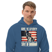 Hoodie with Give Me Liberty or Give Me a Shot of Bourbon text, Statue of Liberty holding a shot glass, and distressed American flag background. Perfect for 4th of July.