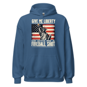 Hoodie with 'Give Me Liberty or Give Me a Fireball Shot' text, Statue of Liberty holding a shot glass, and distressed American flag background. Perfect for 4th of July.