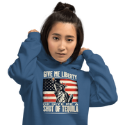 Hoodie with Give Me Liberty or Give Me a Shot of Tequila text, Statue of Liberty holding a shot glass, and distressed American flag background. Perfect for 4th of July.