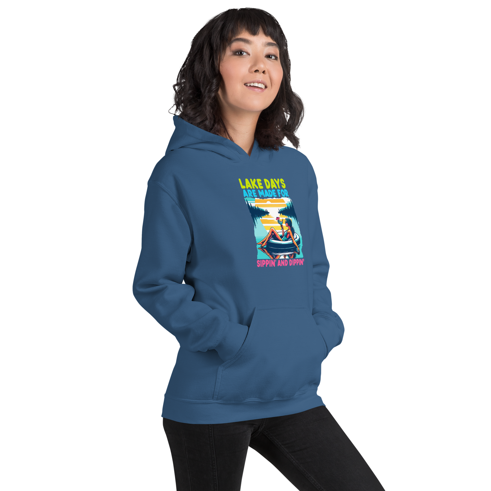 Hoodie with "Lake Days Are Made for Sipping and Dipping," showing a woman on a tube float with a cocktail, lake and sunset scene.