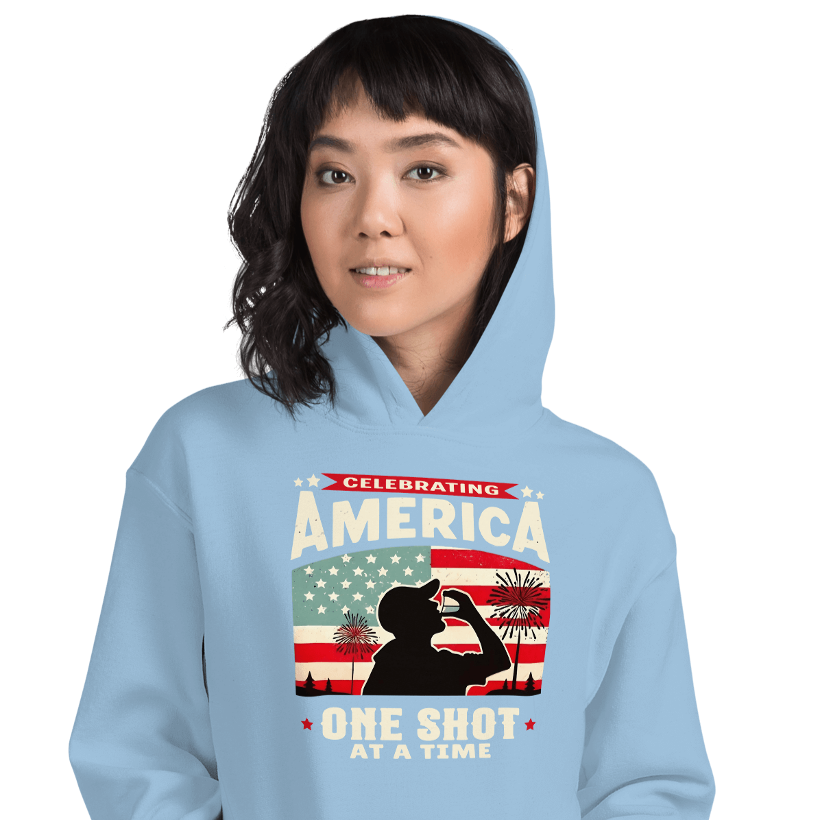 Hoodie with Celebrating America One Shot at a Time text, silhouette of a man drinking a shot, and distressed American flag background. Perfect for 4th of July.