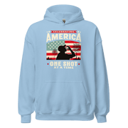 Hoodie with Celebrating America One Shot at a Time text, silhouette of a man drinking a shot, and distressed American flag background. Perfect for 4th of July.