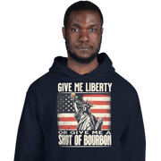 Hoodie with Give Me Liberty or Give Me a Shot of Bourbon text, Statue of Liberty holding a shot glass, and distressed American flag background. Perfect for 4th of July.