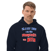 Man wearing a cozy navy blue hoodie with "I'm Just Here for the Fireworks and Beer" text, perfect for cooler evenings.