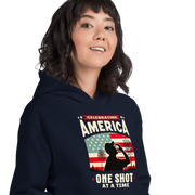 Hoodie with Celebrating America One Shot at a Time text, silhouette of a man drinking a shot, and distressed American flag background. Perfect for 4th of July.