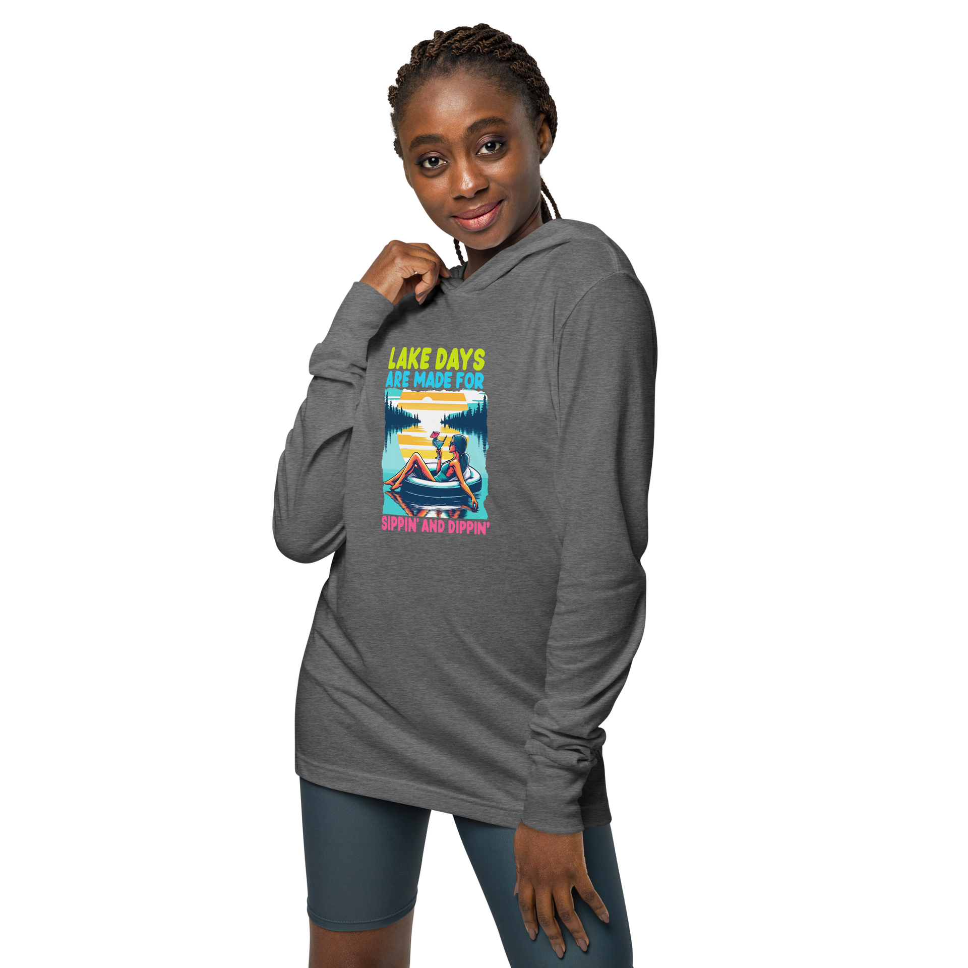 Lightweight hoodie with "Lake Days Are Made for Sipping and Dipping," featuring a woman on a tube float, lake and sunset.