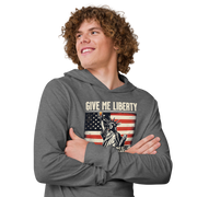 Lightweight hoodie with 'Give Me Liberty or Give Me a Fireball Shot' text, Statue of Liberty holding a shot glass, and distressed American flag background. Perfect for 4th of July."