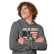 Lightweight hoodie with Give Me Liberty or Give Me a Shot of Bourbon text, Statue of Liberty holding a shot glass, and distressed American flag background. Perfect for 4th of July.