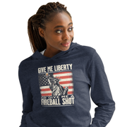 Lightweight hoodie with 'Give Me Liberty or Give Me a Fireball Shot' text, Statue of Liberty holding a shot glass, and distressed American flag background. Perfect for 4th of July."