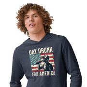 Lightweight hoodie with Day Drunk for America text, silhouette of a man drinking a bottle of beer, and distressed American flag background. Perfect for 4th of July.