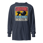 Celebrate fatherhood with our "Surviving Fatherhood One Beer at a Time" lightweight hoodie. Perfect gift for dads on Father's Day or any occasion.