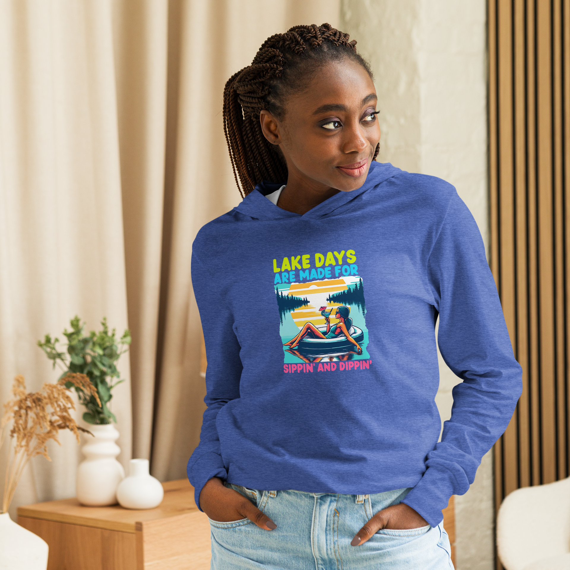 Lightweight hoodie with "Lake Days Are Made for Sipping and Dipping," featuring a woman on a tube float, lake and sunset.