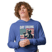 Lightweight hoodie with Day Drunk for America text, silhouette of a man drinking a bottle of beer, and distressed American flag background. Perfect for 4th of July.