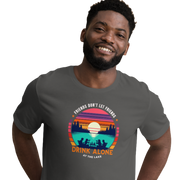 Tee showcasing "Friends Don't Let Friends Drink Alone at the Lake" with a retro sunset and lake scene.