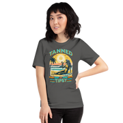 Vintage-inspired 'Tanned and Tipsy' tee with a woman sipping a cocktail on a beach at sunset, perfect for beach drinking and summer parties.