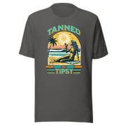 Vintage-inspired 'Tanned and Tipsy' tee with a woman sipping a cocktail on a beach at sunset, perfect for beach drinking and summer parties.