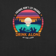 Tee showcasing "Friends Don't Let Friends Drink Alone at the Lake" with a retro sunset and lake scene.