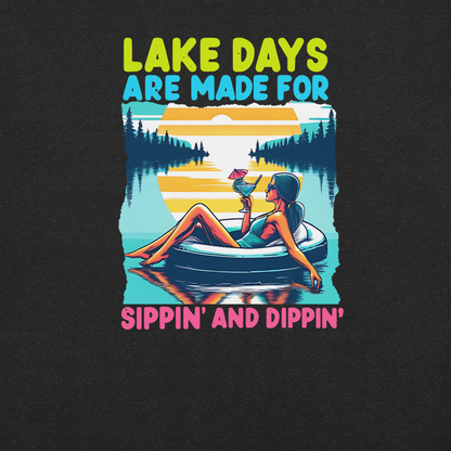 Tee with "Lake Days Are Made for Sipping and Dipping," featuring a woman on a tube float with a cocktail, lake and sunset backdrop.