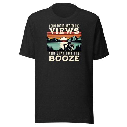 Tee showing "I Come to the Lake for the Views and Stay for the Booze," with a man in a beach chair, lake, and retro sunset.