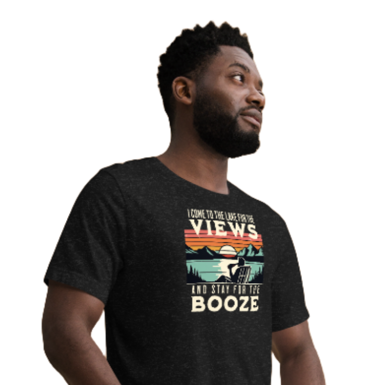 Tee showing "I Come to the Lake for the Views and Stay for the Booze," with a man in a beach chair, lake, and retro sunset.