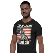 T-shirt with 'Give Me Liberty or Give Me a Fireball Shot' text, Statue of Liberty holding a shot glass, and distressed American flag background.