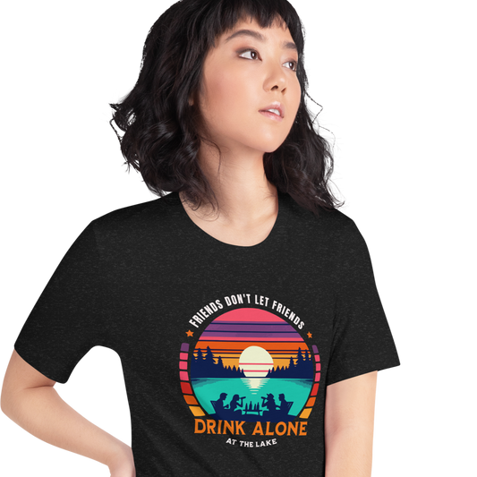 Tee showcasing "Friends Don't Let Friends Drink Alone at the Lake" with a retro sunset and lake scene.