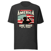 T-shirt with Celebrating America One Shot at a Time text, silhouette of a man drinking a shot, and distressed American flag background. Perfect for 4th of July.