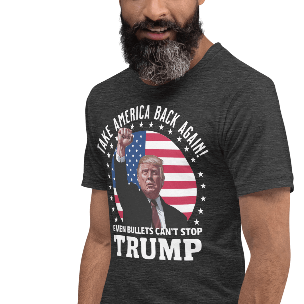 Man wearing "Even Bullets Can't Stop Trump" graphic tee with American flag background.