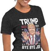 Woman wearing Trump 2024 Bye Bye Joe funny tee with illustration of President Trump waving and American flag motifs.