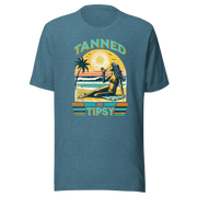 Vintage-inspired 'Tanned and Tipsy' tee with a woman sipping a cocktail on a beach at sunset, perfect for beach drinking and summer parties.