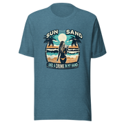 Woman with cocktail on beach on 'Sun, Sand, and a Drink in My Hand' tee, showcasing ocean and sun background