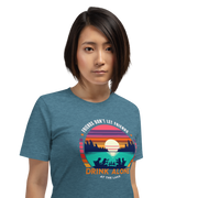 Tee showcasing "Friends Don't Let Friends Drink Alone at the Lake" with a retro sunset and lake scene.