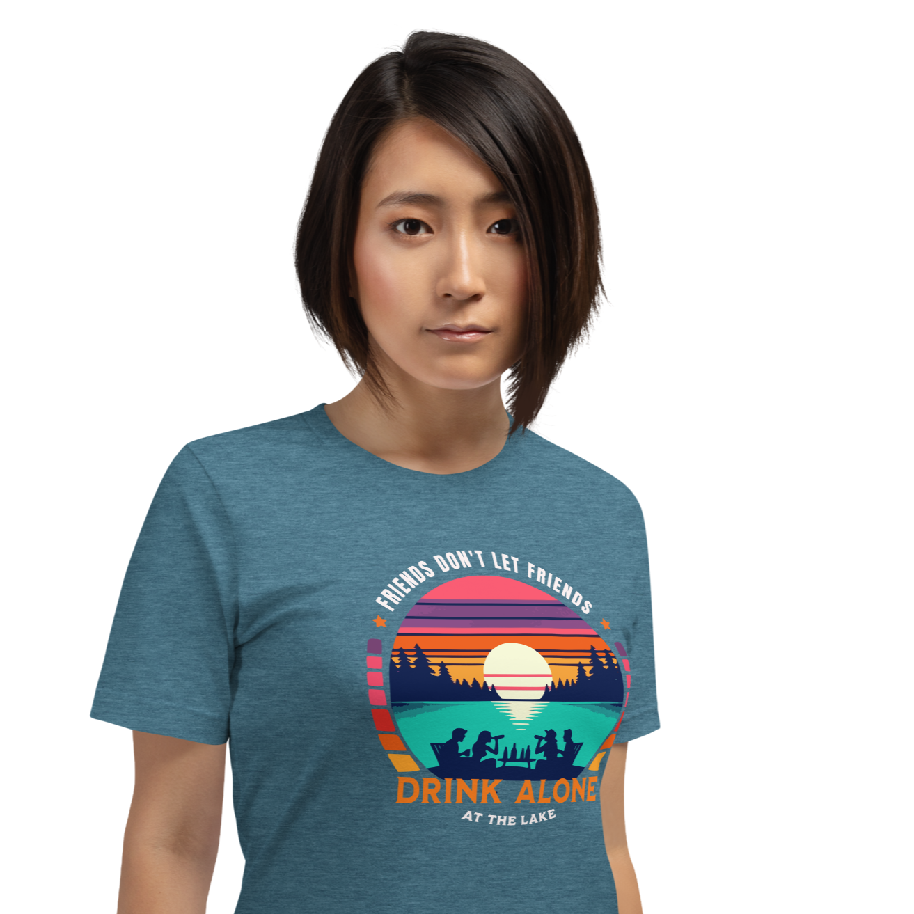 Tee showcasing "Friends Don't Let Friends Drink Alone at the Lake" with a retro sunset and lake scene.