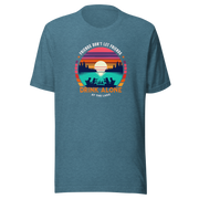 Tee showcasing "Friends Don't Let Friends Drink Alone at the Lake" with a retro sunset and lake scene.