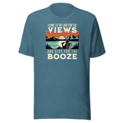 Tee showing "I Come to the Lake for the Views and Stay for the Booze," with a man in a beach chair, lake, and retro sunset.