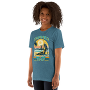 Vintage-inspired 'Tanned and Tipsy' tee with a woman sipping a cocktail on a beach at sunset, perfect for beach drinking and summer parties.