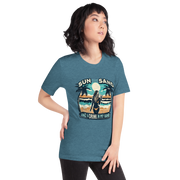 Woman with cocktail on beach on 'Sun, Sand, and a Drink in My Hand' tee, showcasing ocean and sun background