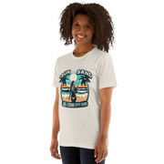 Woman with cocktail on beach on 'Sun, Sand, and a Drink in My Hand' tee, showcasing ocean and sun background