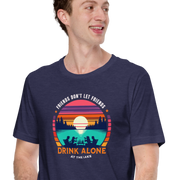 Tee showcasing "Friends Don't Let Friends Drink Alone at the Lake" with a retro sunset and lake scene.