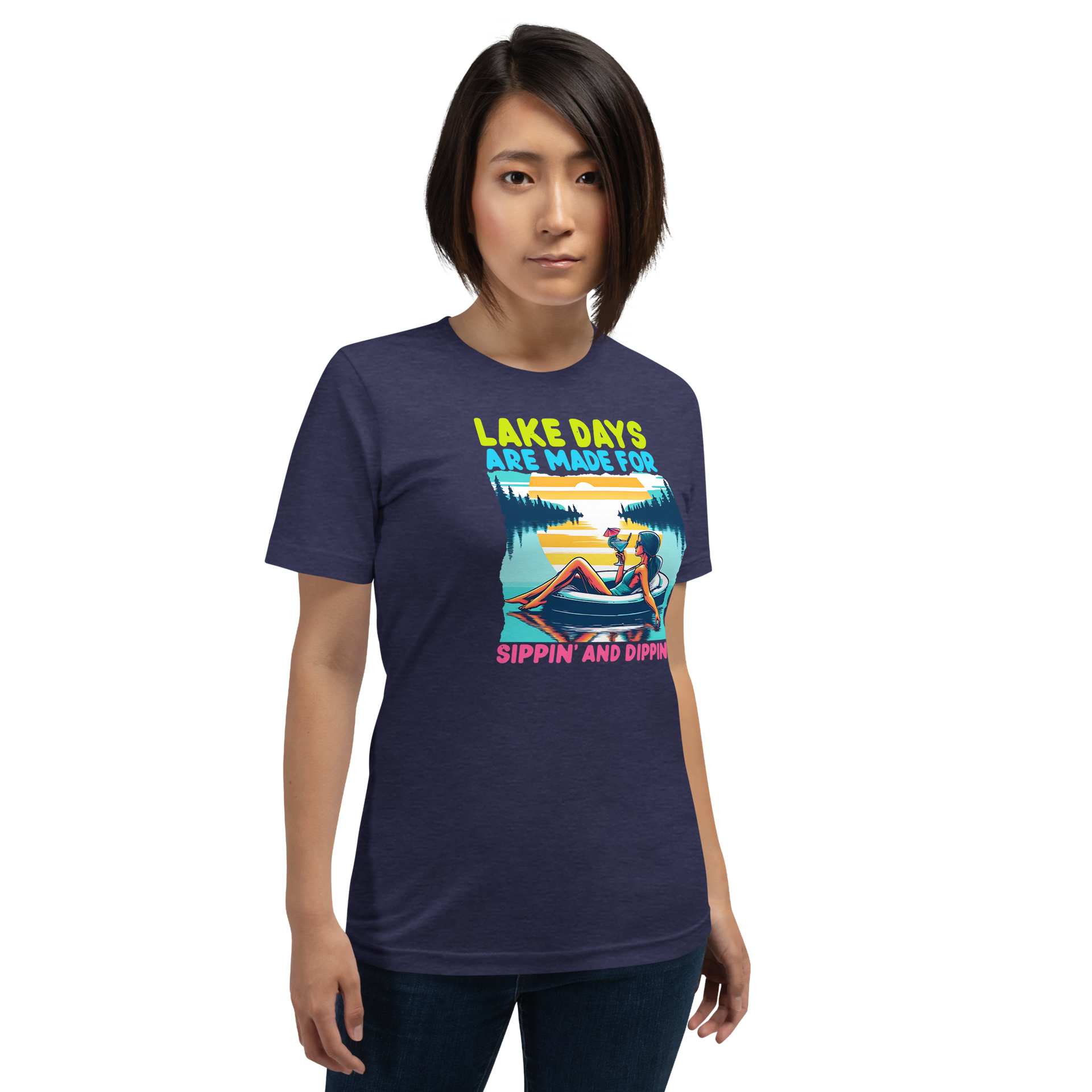 Tee with "Lake Days Are Made for Sipping and Dipping," featuring a woman on a tube float with a cocktail, lake and sunset backdrop.