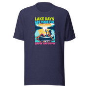 Tee with "Lake Days Are Made for Sipping and Dipping," featuring a woman on a tube float with a cocktail, lake and sunset backdrop.