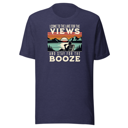 Tee showing "I Come to the Lake for the Views and Stay for the Booze," with a man in a beach chair, lake, and retro sunset.