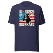 4th of July T-shirt with '100% American Drunkard' text, man drinking a bottle of beer wearing a trucker hat, and distressed American flag background