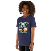 Woman with cocktail on beach on 'Sun, Sand, and a Drink in My Hand' tee, showcasing ocean and sun background